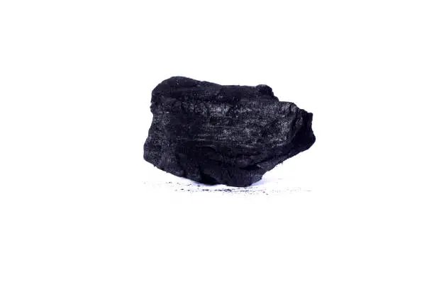 Close up view of some black coal isolated on a white background.