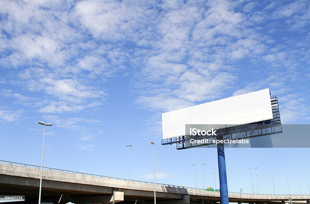 A large blank billboard near a main road on a cloudy day A blank billboard with an elevated highway in the background Billboard Stock Photo