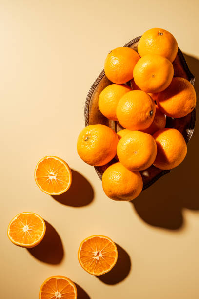 istock Flat lay with tangerines in metal bowl on beige backdrop 1064074624