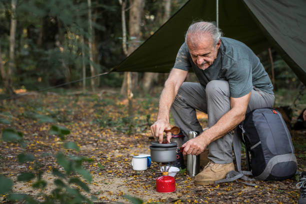 istock Mature man cooking at a campsite 1064076838