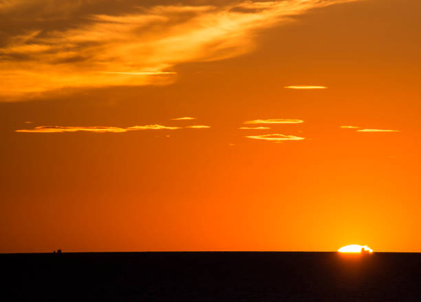 istock Boat silhouette against sunrice scene 1064076884