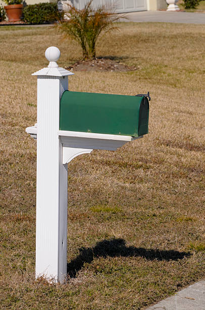 istock Green Mail Box on a White Wooden Pole 106407843