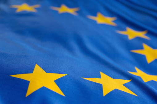 Close-up view of the European Union flag waving in the wind. The European Union is a political and economic union of 27 member states that are located primarily in Europe