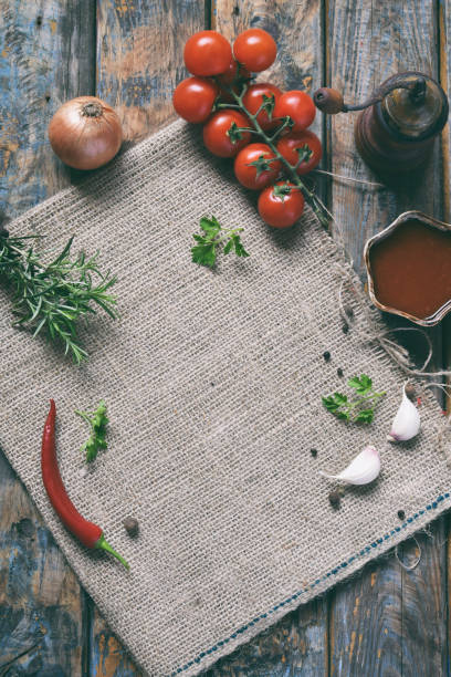 istock Rustic composition with pepper mill, tomato souce, fresh herbs, vegetables and spices. Country style. Baking or cooking background. Copy space for text, menu, recipes. 1064080528
