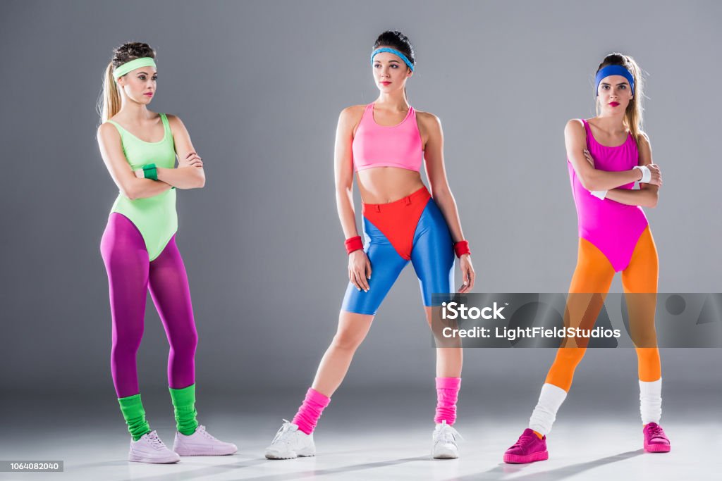 Full Length View Of Athletic Young Women In 80s Style Sportswear Posing On  Grey Stock Photo - Download Image Now - iStock