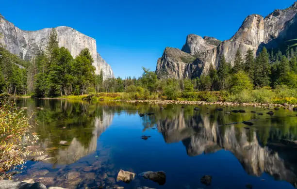 El Capitan, Half Dome, and Bridalveil Fall reflected on Merced river in Yosemite National Park. California. USA