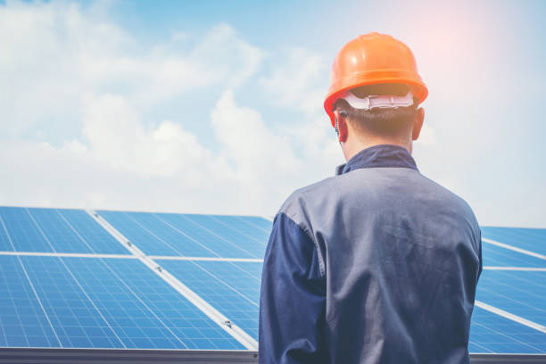 istock engineer or electrician working on  maintenance equipment at industry solar power;  engineer using thermal imager to check temperature heat of solar panel 1064082454