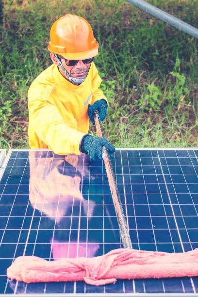 istock labor working on cleaning solar panel with water clean at solar power plant 1064082530