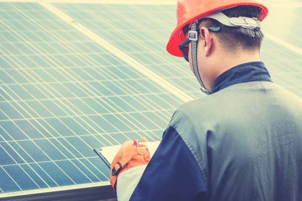istock engineers operating and check generating power of solar power plant on solar rooftop; technician in industry uniform on level of job description at industrial 1064082596