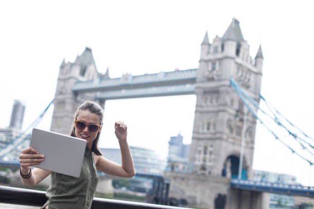 istock Tourist taking selfie in front of Tower bridge 1064083624