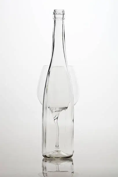 Empty Wineglass and winebottle, on white background