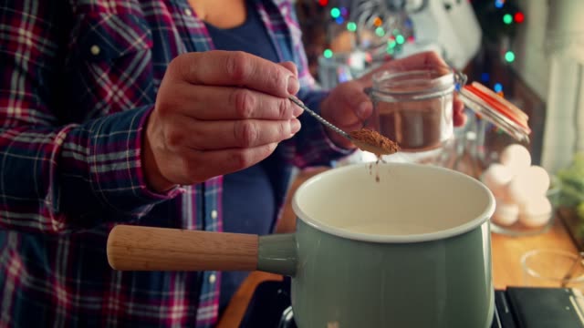 Preparing Creamy Eggnog with Cinnamon for Christmas