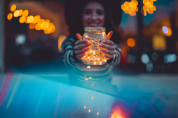 istock Cheerful woman with Christmas lights 1064101308