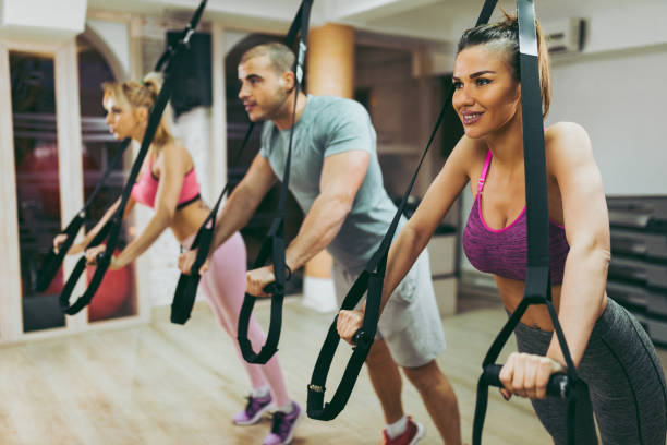 istock TRX suspension training- people doing arm and leg exercises 1064104238