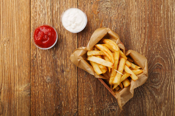 istock Serving Belgian fries served in a paper box. With or without a dip. 1064106564