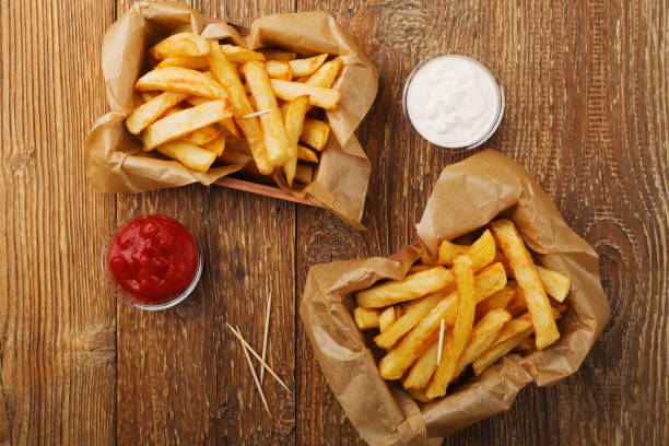 istock Serving Belgian fries served in a paper box. With or without a dip. 1064106670