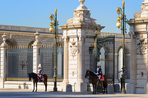 Madrid, Spain - October 24, 2018: Entrance gate to the Royal Palace of Madrid with Royal guard on horseback