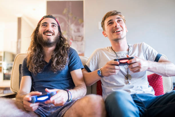 istock Happy young males playing video game at home 1064108544