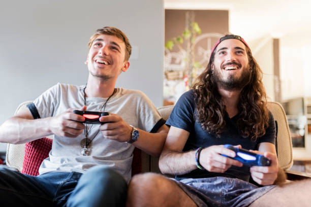 istock Happy young male hipsters playing video game 1064108576