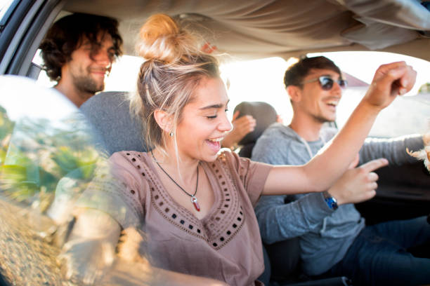 istock Friends dancing in car during road trip 1064108928