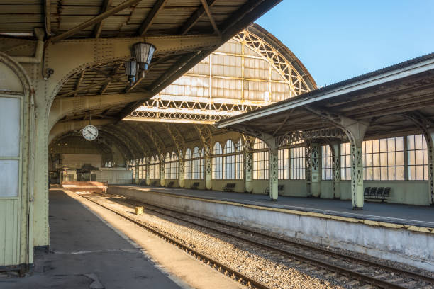 istock Old railway station with a platform clock empty without people. 1064110006