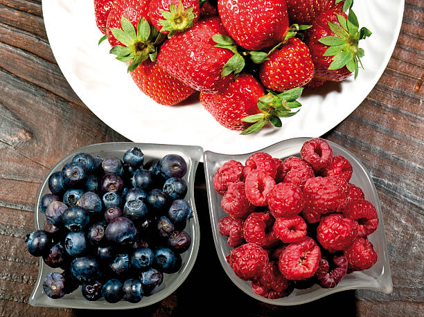 Raspberry strawberries and blueberries stock photo