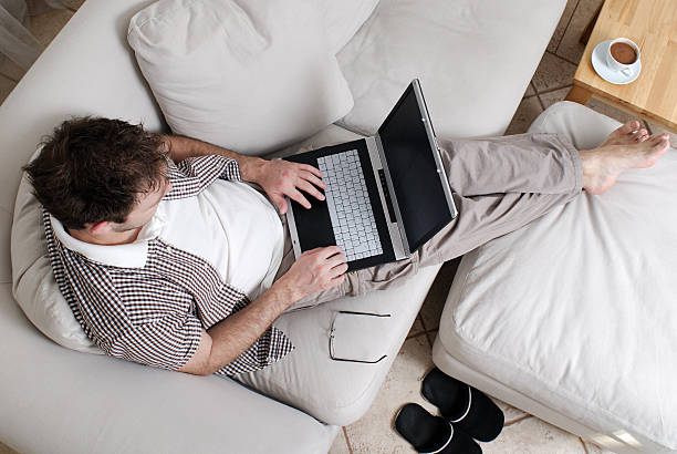 istock Young man working at home on a laptop 106411100