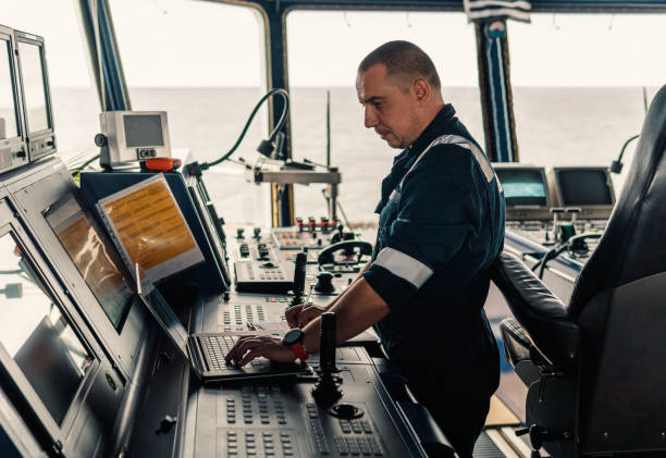 istock Marine navigational officer is using laptop or notebook at sea 1064111680