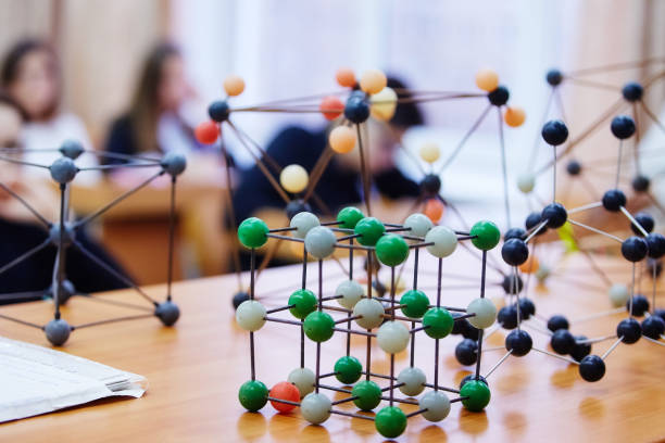 istock Students sit in the classroom and listen to a lecture in science. Plastic molecular educational model. Soft focus background image 1064112170