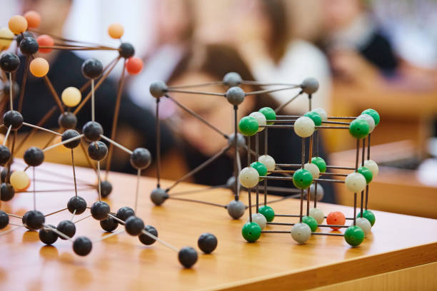 istock Students sit in the classroom and listen to a lecture in science. Plastic molecular educational model. Soft focus background image 1064112198