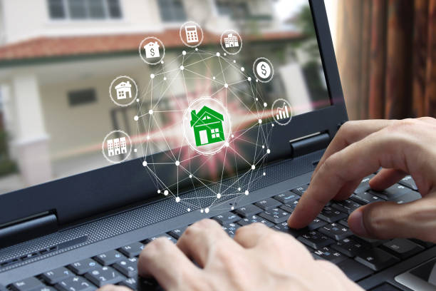 istock Hand use laptop computer with property investment icons 1064115896
