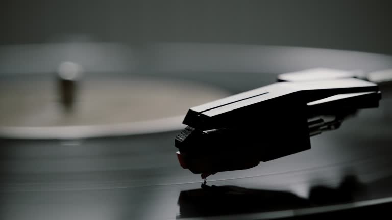 Black and white, stylus and record turntable.