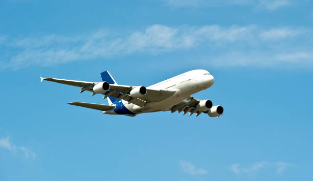 istock Airplane A380 flying through blue skies 106412125