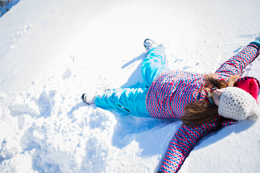 Teenage girl enjoys at snowy mountain