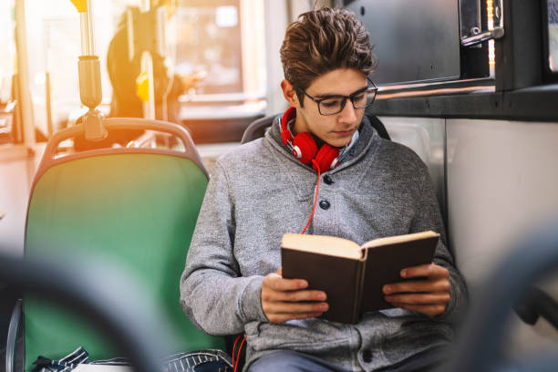 istock Teenage in a bus learning for exam 1064122252