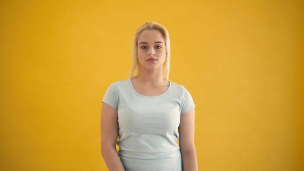 istock Attractive young caucasian blond plus size model look to the camera yellow background 1064128658