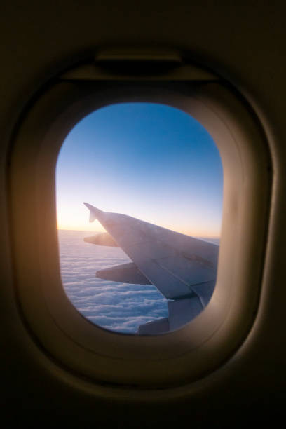 istock Morning light from window of  airplane wing 1064130514