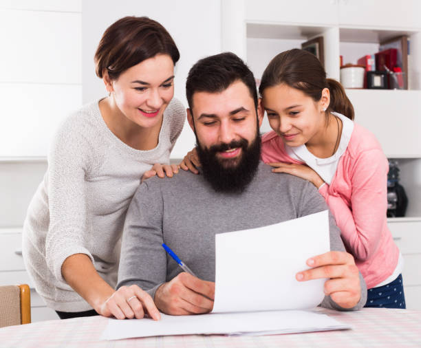 istock Parents signing property papers 1064135084
