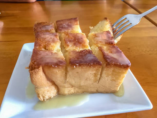 istock honey toast on white dish and spoon,fork on wooden table 1064135314