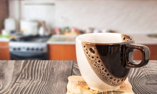istock coffee cup on the table against the background of the kitchen 1064135474