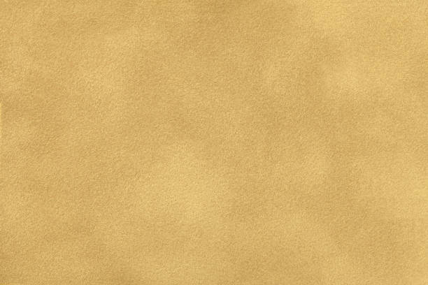 Ocher matt suede fabric closeup. Velvet texture.