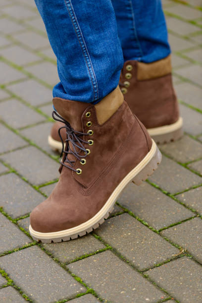 istock Brown autumn boots on men legs 1064137154