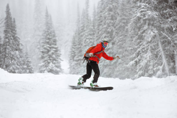 istock Snowboarder female off-piste forest ski slope 1064142184
