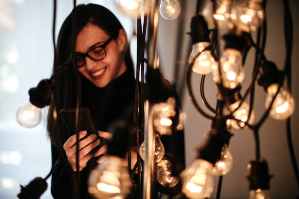 istock Young woman talking on mobile phone and decorating her office 1064145880