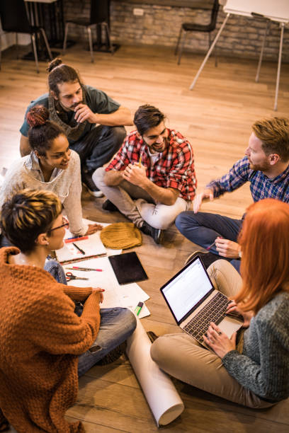 istock Above view of team of entrepreneurs communicating while developing new business strategy at casual office. 1064146324