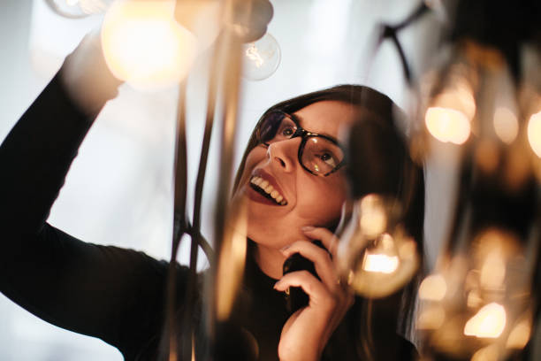 istock Young woman talking on mobile phone and decorating her office 1064147856