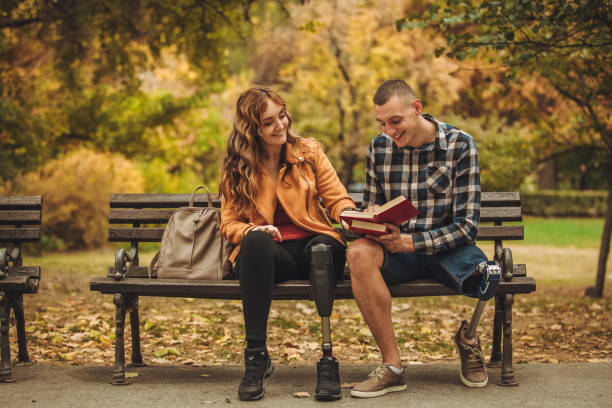 istock Disability friends sitting in park 1064148400
