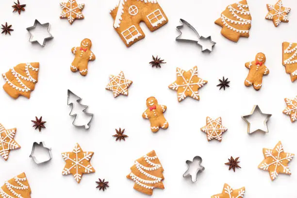 Christmas pattern. Various gingerbread cookies and forms on white background, top view