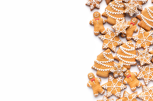 Border of homemade christmas gingerbread cookies on white background with copy space for text