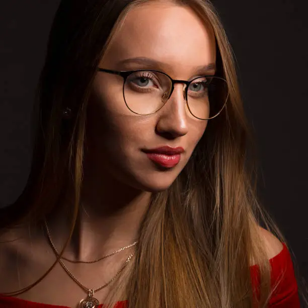 Beautiful blonde girl with long hair in glasses. European fashion model and natural beauty.